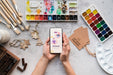 Free Acrylic Palette And Brushes Beside Mobile Psd