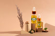 Free Argan Oil Cosmetic Bottle Mock-Up With Wooden-Shaped Podium And Kernels Psd
