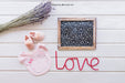 Free Baby Mockup With Slate And Pink Bib Psd