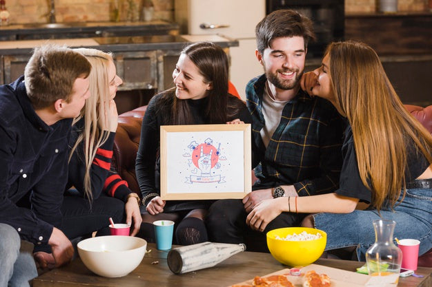 Free Friends At A Party Holding A Frame Mock-Up Psd