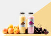 Free Front View Of Clear Juice Bottles With Cherries And Peaches Psd