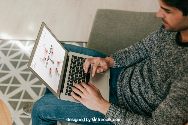 Free Man Using Laptop On Couch Psd