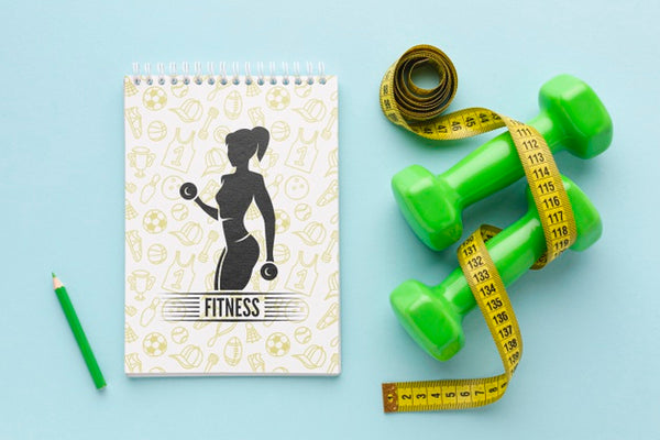 Free Notebook Beside Fitness Equipment Psd