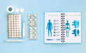 Free Notebook With Pills On Table Psd