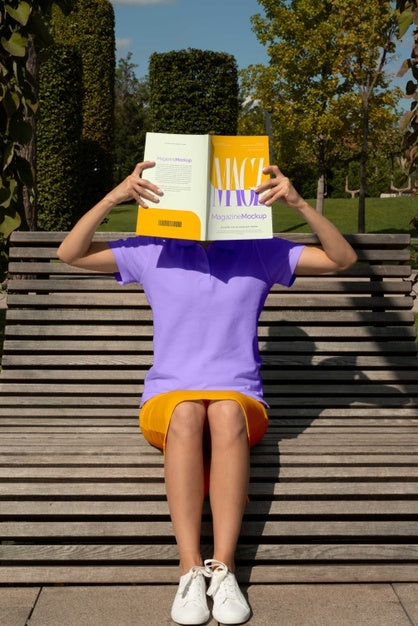 Free Person Reading Color Pop Magazine With Cover Mockup Psd
