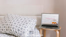 Free Technology Mockup With Laptop Next To Bed Psd