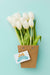 Free Top View Of White Tulips With Card Psd