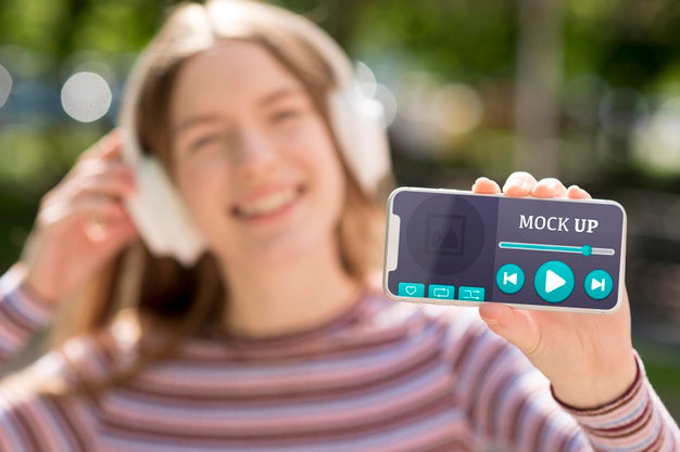 Free Woman Holding Phone With Music App Mock-Up Psd