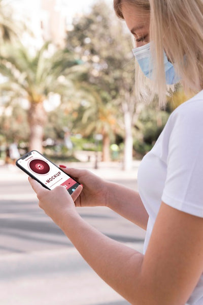 Free Woman With Mask On Street Reading Book On Phone Psd